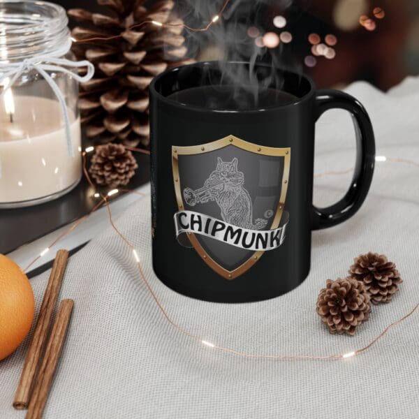 A steaming black Police Car Coffee Mug sits on a tablecloth next to pine cones, cinnamon sticks, an orange, and a lit candle.