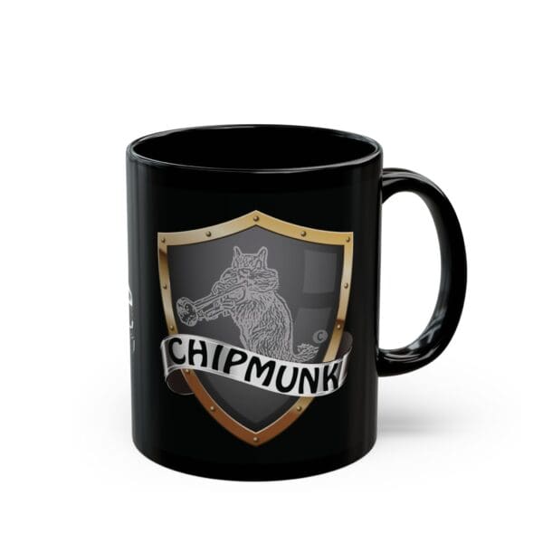 The Ambulance Coffee Mug is a black mug that features a shield emblem with a drawing of a chipmunk playing a trumpet, labeled "ChIPMUNK" on a banner across the shield.