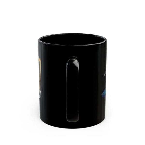 A "Land, Sea, and Air Coffee Mug" crafted from black ceramic, adorned with detailed illustrations on its surface, displayed against a plain white background.