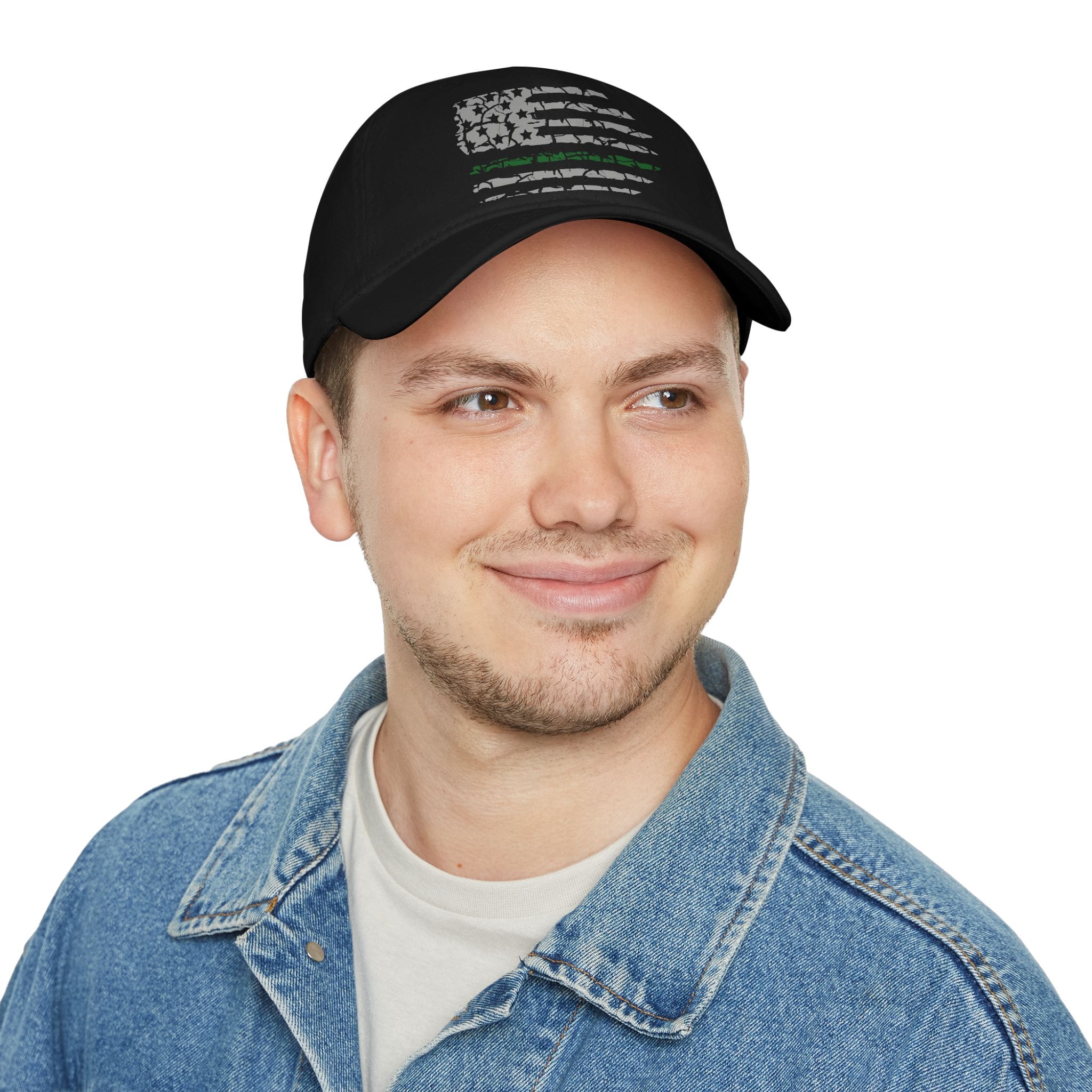 A young person smiling and dressed in a denim jacket over a light grey shirt, wearing the Military Support Low Profile Baseball Hat, which features an American flag design with a green line.