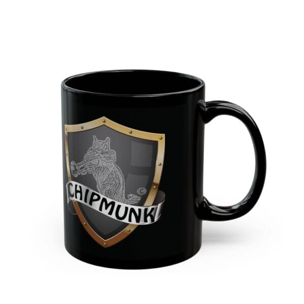 The Chipmunk Coffee Mug is a black ceramic mug featuring a shield emblem with a detailed sketch of a chipmunk eating a nut and the word "CHIPMUNK!" written below.