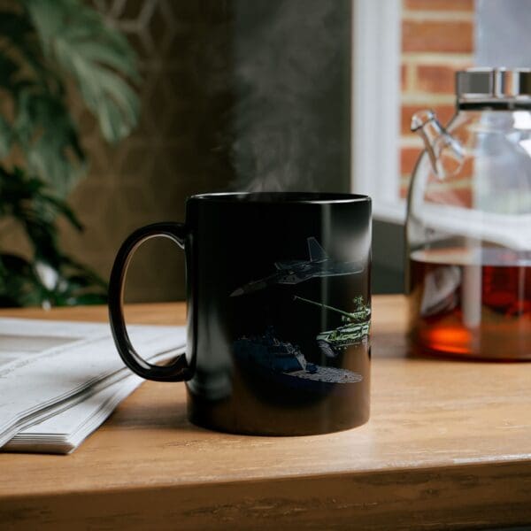 The Land, Sea, and Air Coffee Mug featuring a spaceship and tank design sits on a wooden table near a glass pot of coffee, a newspaper, and a plant in the background.