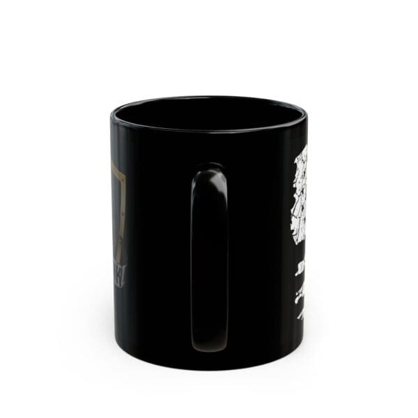 An American Pride Coffee Mug, featuring black color with white and gold designs, is positioned with its handle facing forward.