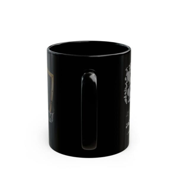 A Correctional Officer Support Coffee Mug is shown with its handle facing forward. The black ceramic mug appears to have some graphics or designs on the sides, though they are not fully visible in the image.