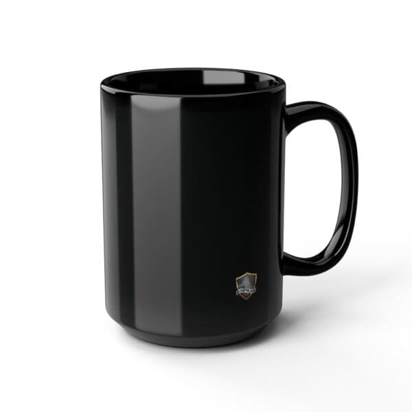 An Angry Cat Coffee Mug (both 11oz and 15oz options) in a glossy black finish, featuring a small shield logo near the base, set against a white background.