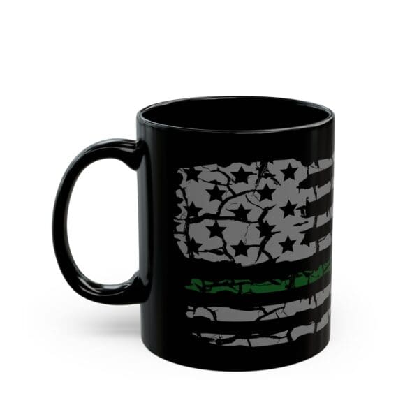 The Military Support Coffee Mug is a black coffee mug featuring a distressed American flag design with a green line running through the middle stripe.