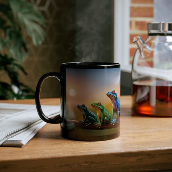 A steaming Colorful Frogs Coffee Mug, available in 11oz and 15oz sizes, sits on a wooden table beside a newspaper and a glass coffee pot.