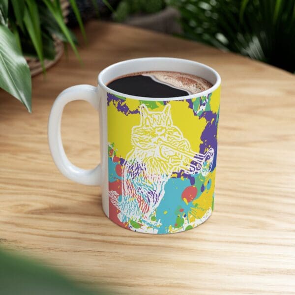 The Splash Chipmunk Coffee Mug, adorned with a vibrant, multicolored abstract design showcasing a wolf playing a trumpet, is placed on a wooden surface with green plants in the background.