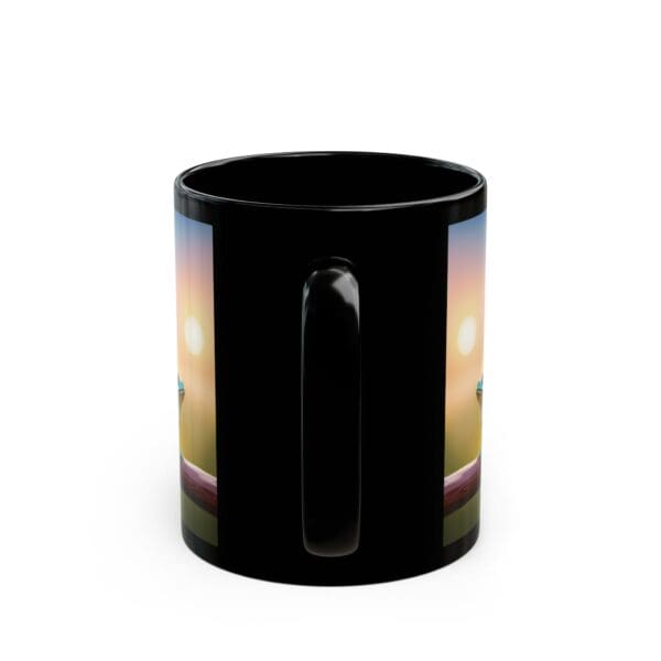 A black coffee mug from the Colorful Frogs collection, showcasing a detailed landscape design with a radiant sunset and a lighthouse on both sides. Available in 11oz and 15oz sizes.