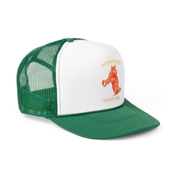 A green and white trucker hat with a mesh back, featuring an orange graphic of an owl and the text "Put Your Lips To Good Use.