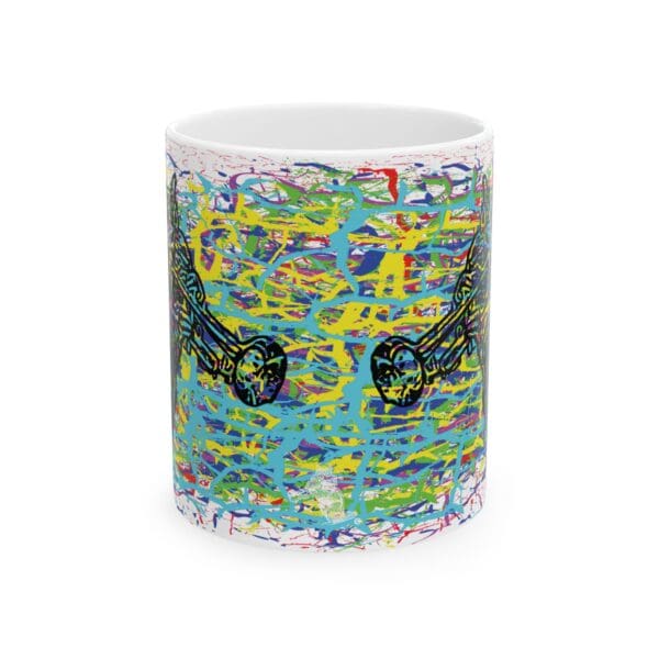 The Cracked Chipmunk Coffee Mug is a vibrant ceramic mug adorned with a pattern of black abstract shapes and splashes of blue, yellow, pink, and red paint.