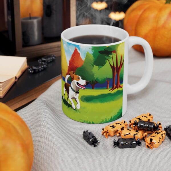 A Playful Dog Coffee Mug 11oz, featuring a colorful illustration of a dog in a park setting, filled with steaming coffee and placed on a table surrounded by pumpkins, wrapped candies, and an open notebook.