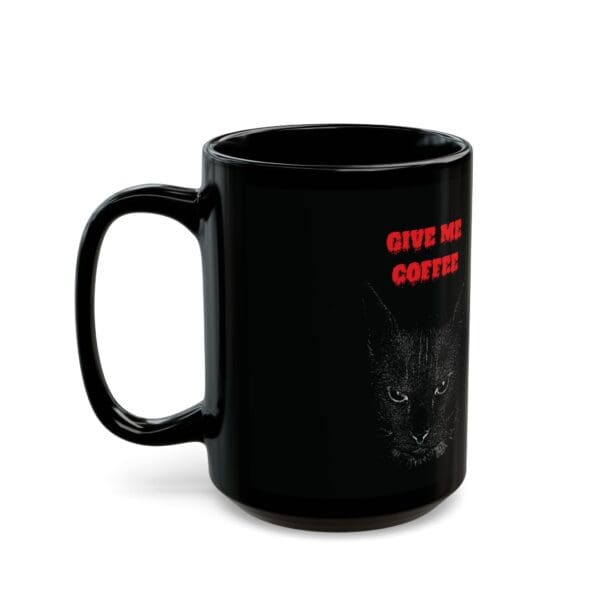 Introducing the "Angry Cat Coffee Mug," available in 11oz and 15oz sizes, featuring a black design with an illustration of a cat's face and the text "GIVE ME COFFEE" in bold red letters.