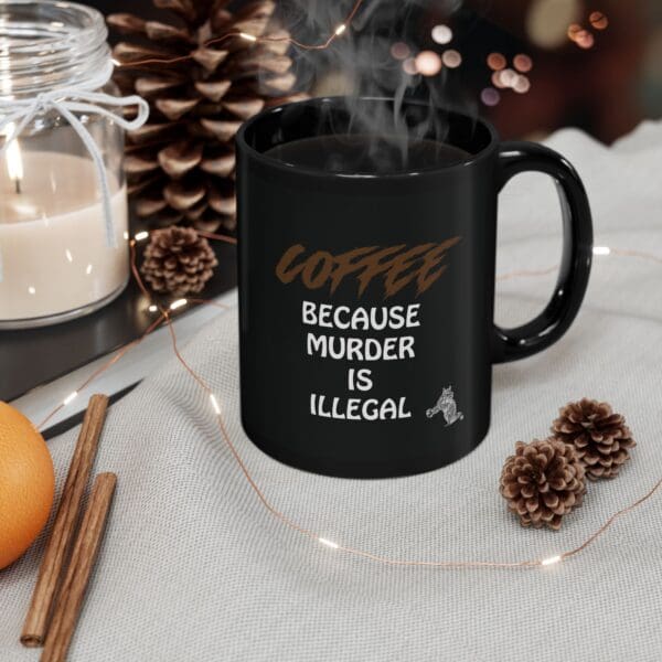 A "Coffee Because Murder Is Illegal" coffee mug sits on a cloth next to a lit candle, pine cones, cinnamon sticks, and an orange slice.