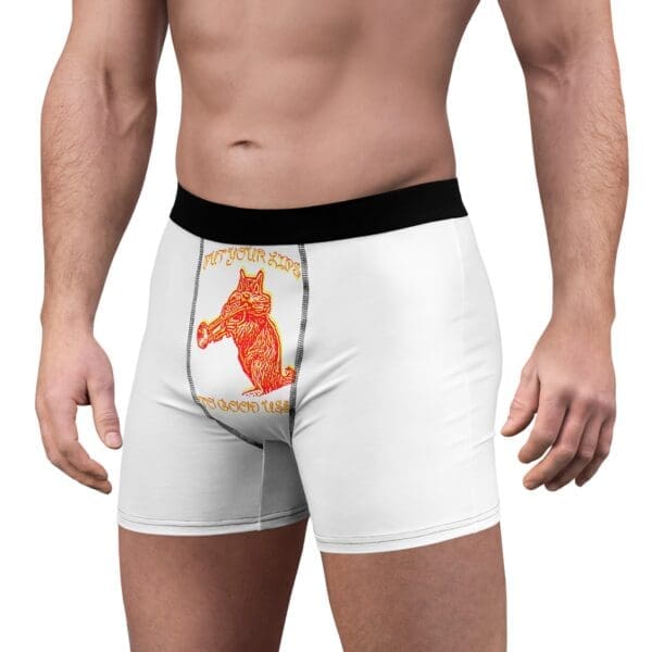 A person is wearing Them Lips To Good Use Men's Boxer Briefs, which are white with a black waistband and feature a red image of a cat holding a hammer along with the text "PUT YOUR TOOLS TO GOOD USE.