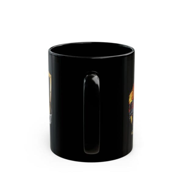 A Firetruck Coffee Cup, made from black ceramic and equipped with a handle, is displayed from an angle that accentuates one side of the cup adorned with vibrant graphic elements partially obscured in this perspective.