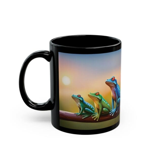 A black Colorful Frogs Coffee Mug (available in 11oz and 15oz) featuring a vibrant illustration of three frogs sitting on a branch against a sunset background.