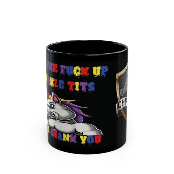 A black mug featuring a vibrant graphic of an angry unicorn and a shield, adorned with the text "Back the F*** Up, Sparkle Tits!" in multiple colors.