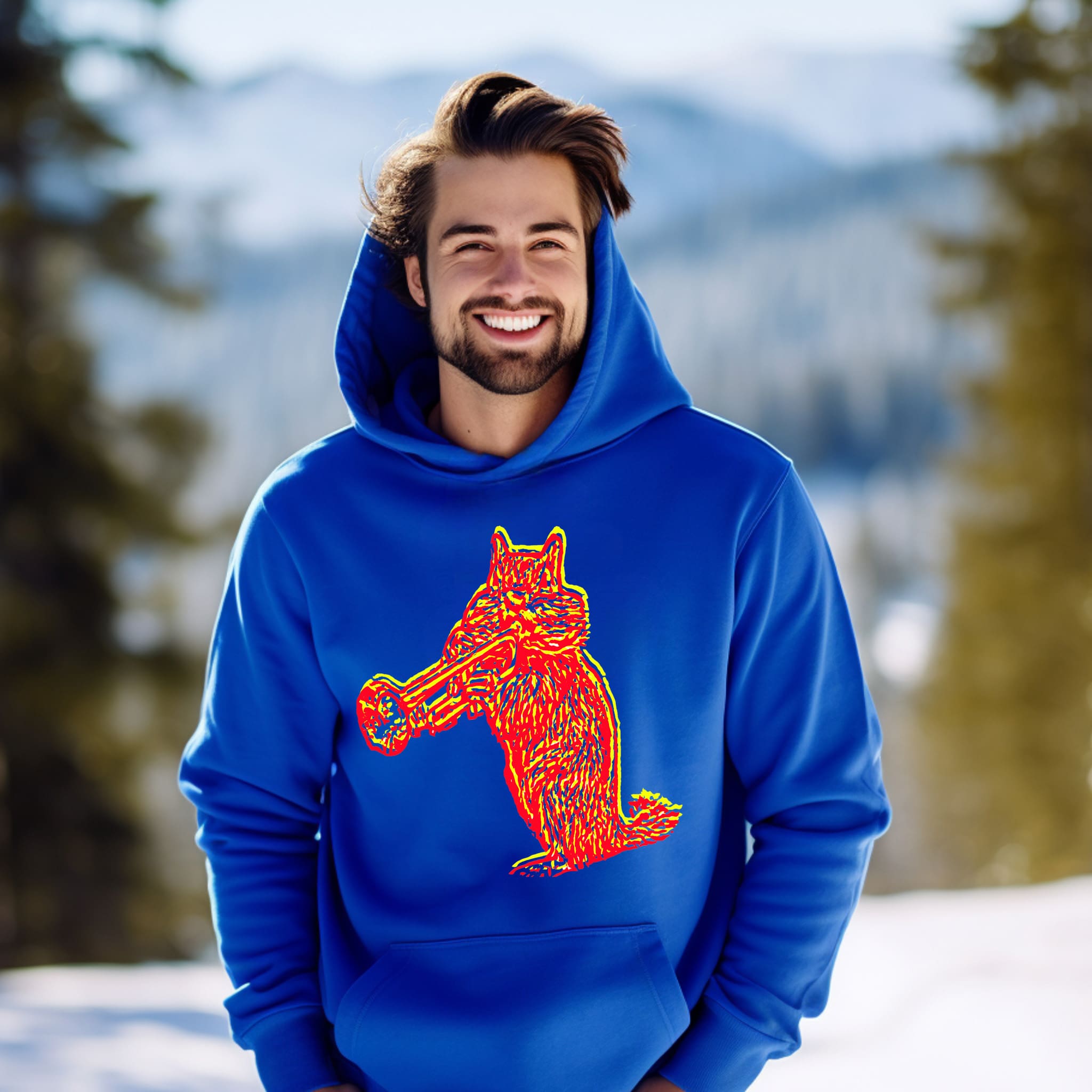 A man wearing a Chipmunk Hoodie with a graphic of a squirrel playing a trumpet stands outside in a snowy, mountainous area.