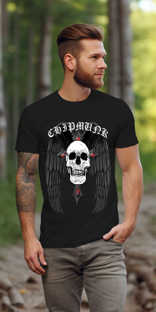 A bearded man with tattoos is standing outdoors wearing a Gothic Art T-Shirt, which features a black design with a skull and wings graphic and the word "CHIPMUNK" above it.