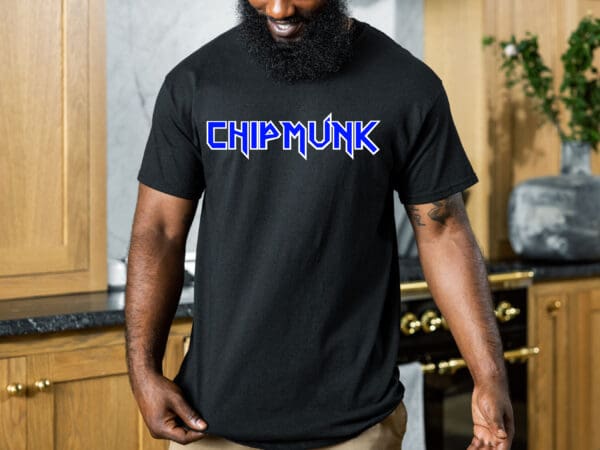 A bearded individual wearing a black Chipmunk Rock T-Shirt #8 with "CHIPMUNK" printed in blue is standing in a kitchen.