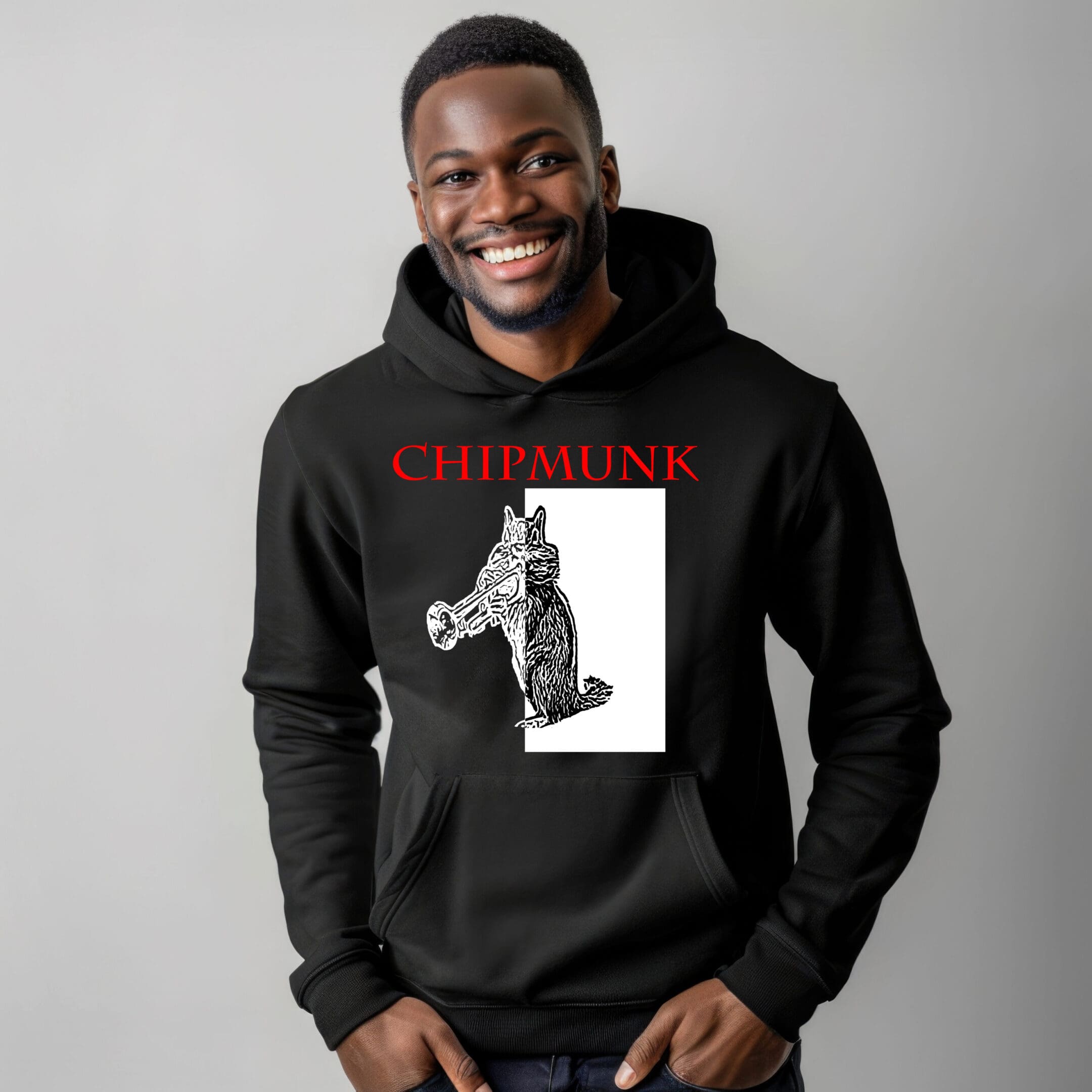 A man smiling and wearing the Chipmunk Hoodie, which features the word "CHIPMUNK" above an image of an anthropomorphic chipmunk holding a trumpet.