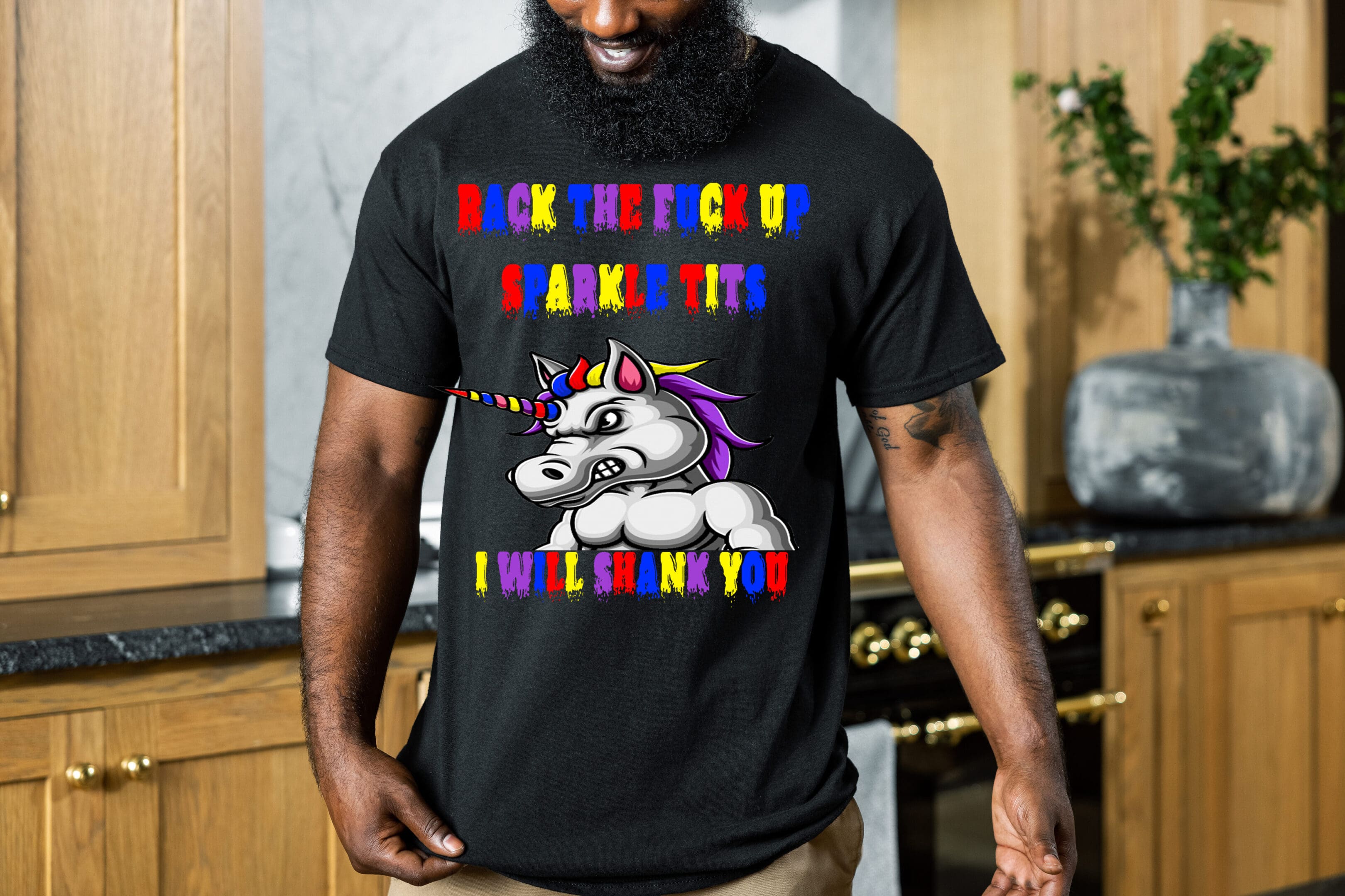 A person wears the Colorful Angry Unicorn Tee, which features an illustration of an angry unicorn and text that reads, "Back the fuck up sparkle tits, I will shank you," in vibrant letters.