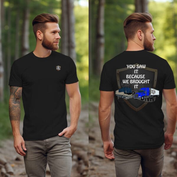 A bearded, tattooed man sports the "You Saw It Because We Brought It" T-Shirt, a black attire featuring a small emblem on the front and a striking shield design on the back with images of vehicles and the slogan, "You saw it because we brought it.