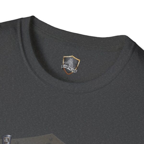 Close-up of an Admission T-Shirt in dark gray featuring a "Chipmunk" logo and shield emblem on the neckline.