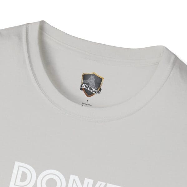 White t-shirt with a partial view of the "Don't Be A..." text in white. Black and gray label inside the collar reads "CHIPMUNK.