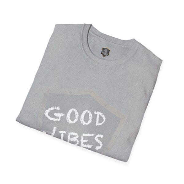 A folded gray t-shirt with a partially visible text design featuring the phrase "Good Vibes Only" in white letters.