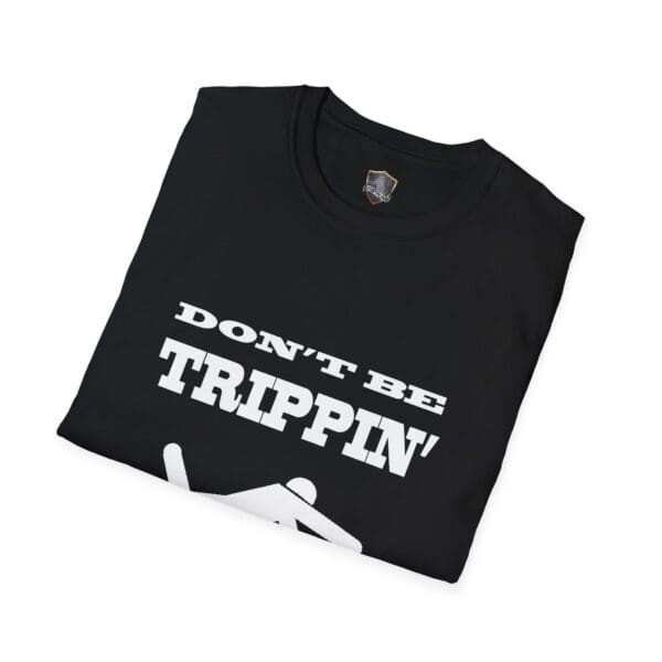 Folded black "Don't Be Trippin'" T-shirt featuring bold white text on the front.