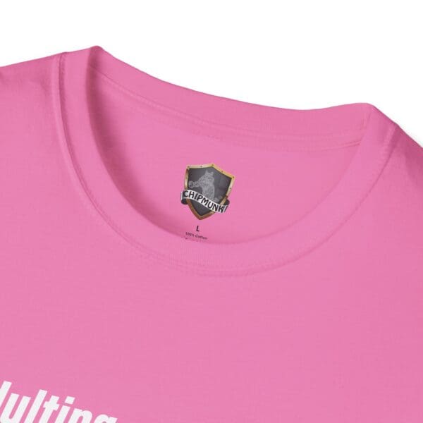 Close-up of a pink T-shirt displaying a tag that reads, "Adulting 1-Star Review" and "100% Cotton L.