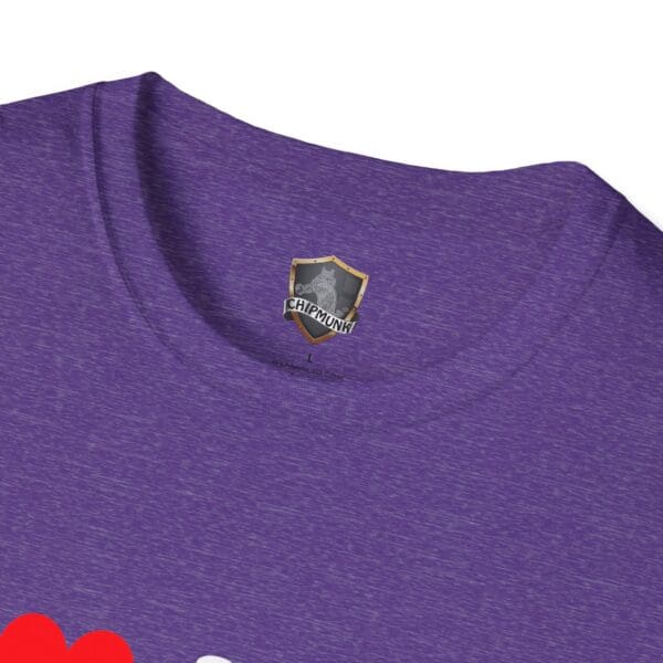 A close-up of a purple heather t-shirt, named "I ❤️ Mom Bods," featuring a "CHIPMUNK" logo on the inside collar and part of its red graphic design on the front.