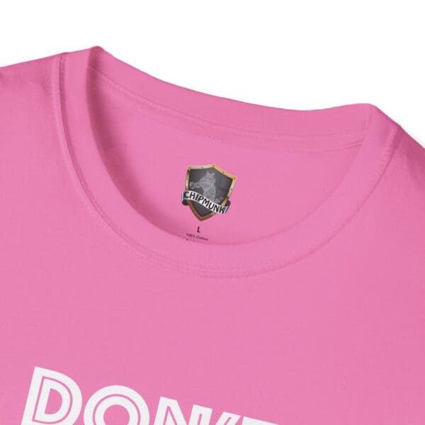 Close-up of a pink "Don't Be A... Tee" with the word "PONK" partially visible and a Chipmunk logo on the inside collar tag.