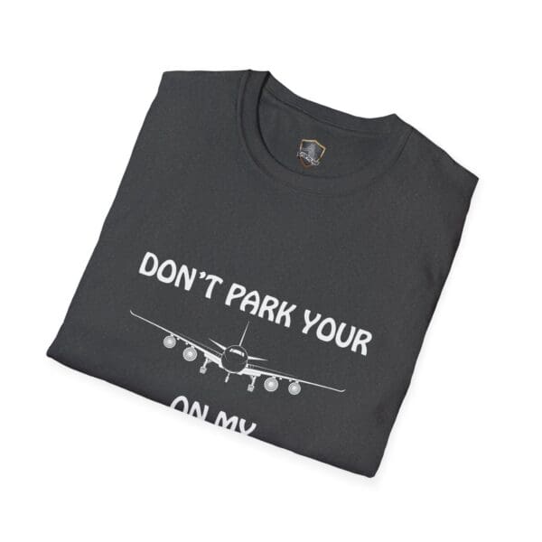 Folded black "Don't Park Your Plane On My Dingy T-Shirt" featuring a graphic of an airplane and the text "DON'T PARK YOUR PLANE ON MY HOUSE" printed on it.