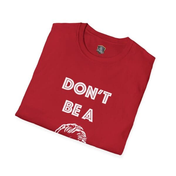 A folded red Don't Be A... Tee featuring partially visible text and a drawing on the front.