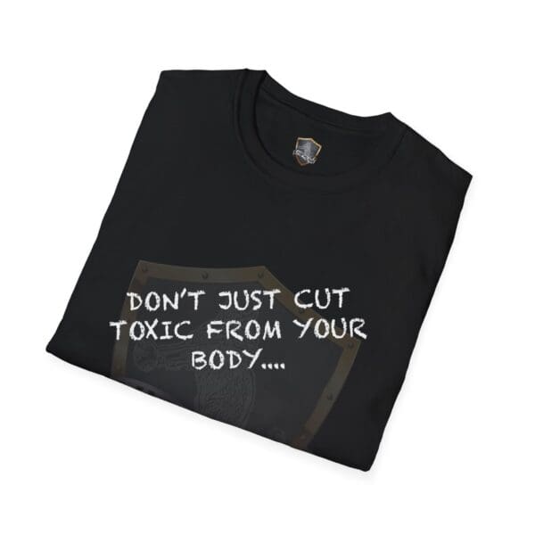 A folded black t-shirt featuring the design: "DON'T JUST CUT TOXIC FROM YOUR BODY, CUT IT FROM YOUR LIFE!" in white text alongside a partially visible shield graphic.