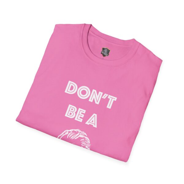 A folded pink "Don't Be A..." T-shirt with white lettering partially visible.