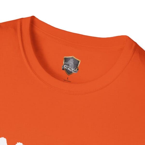 Close-up of an orange T-shirt with a Camel Tow brand label inside the collar.