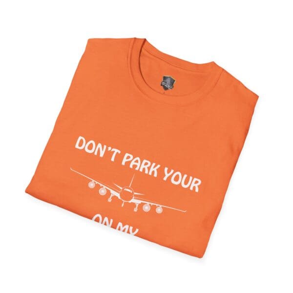 An orange T-shirt featuring a white airplane graphic and the text "DON'T PARK YOUR" on the front, from the "Don't Park Your Plane On My Dingy T-Shirt" collection.