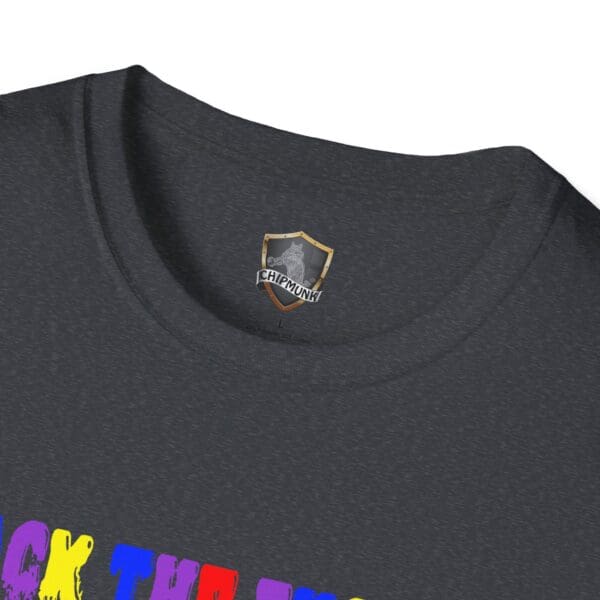 Close-up of the neck of a dark T-shirt featuring a small Chipmunk logo on the inner tag. Slightly visible at the bottom is part of the colorful text from the Colorful Angry Unicorn Tee.