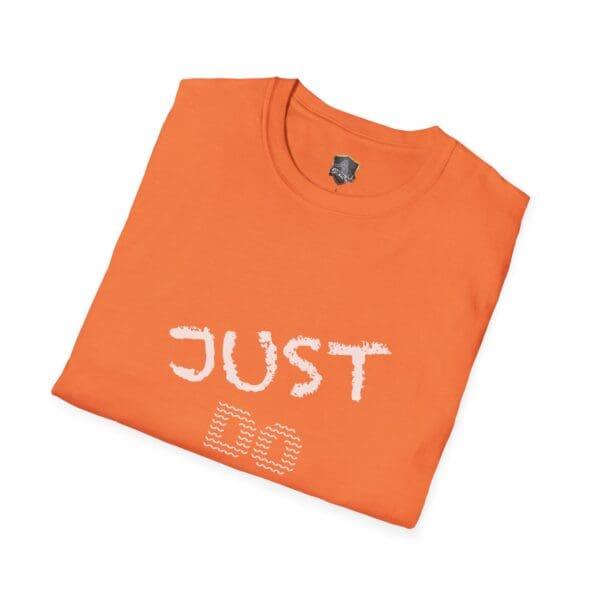 Folded orange t-shirt featuring white text that reads "Just Do Your Job!" on the front.