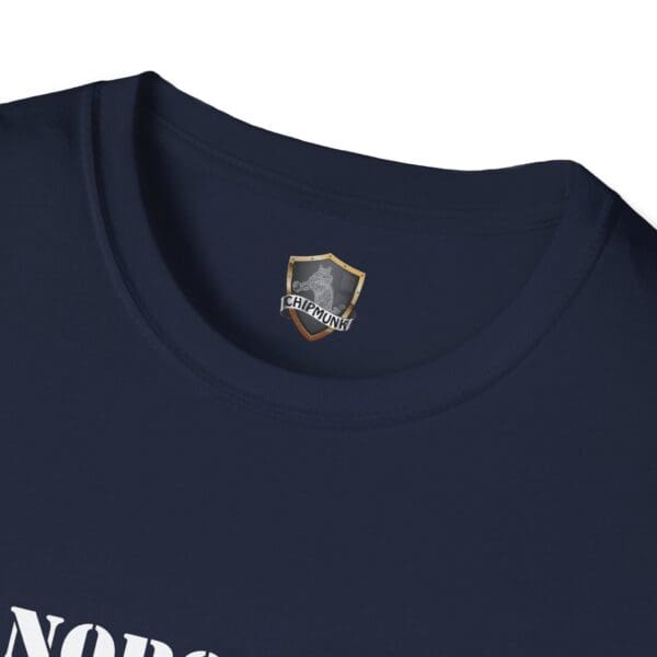 A close-up of the "Nobody Is Perfect" Statement T-Shirt in dark blue, featuring the word "NORS" partially visible. Near the neckline on the inside, there is a small crest along with the word "CHIPMUNK" printed.