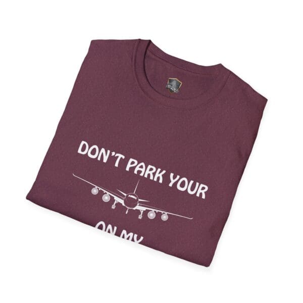 A folded maroon Don't Park Your Plane On My Dingy T-Shirt featuring an airplane illustration and the text "DON'T PARK YOUR PLANE ON MY HOUSE.