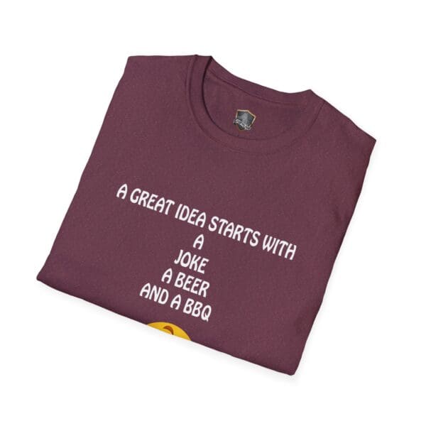 Folded maroon Great Idea T-Shirt with the text: "A great idea starts with a joke, a beer, and a BBQ.