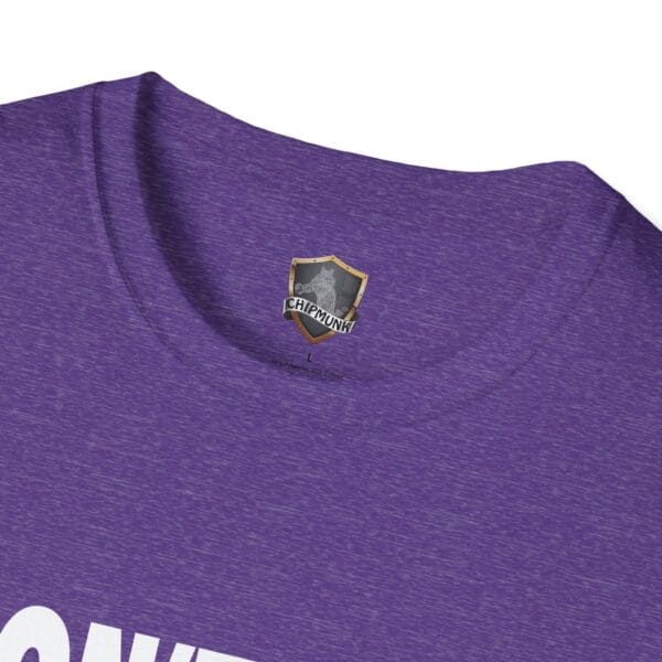 Close-up of the neckline of a purple "Don't Be a Karen" t-shirt, featuring a small shield logo with the word "Chipmunk" inside the collar and partially visible white text at the bottom.