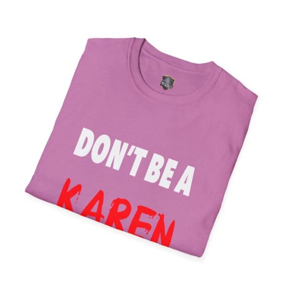 Neatly folded pink "Don't Be a Karen" T-shirt featuring white and red text.