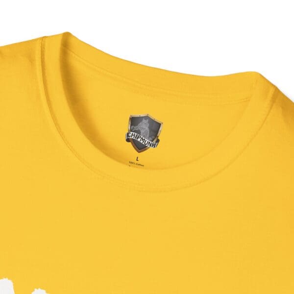 Close-up of a yellow T-shirt with a printed label displaying a shield emblem featuring the text "Chipmunk" and size "L," crafted from 100% cotton, under the product name "Camel Tow.