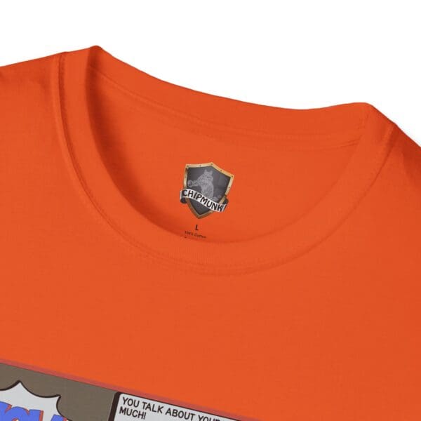 Close-up of an orange Overt Narcissism - Forgetting Myself Graphic Tee with a Chipmunk brand logo and a comic-style graphic near the collar.